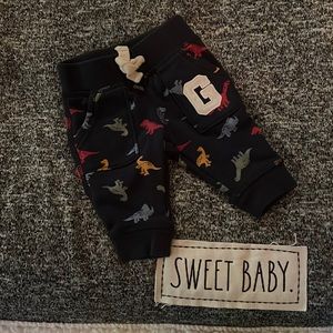 Navy blue baby gap size 0-3 months joggers with multi colored dinosaurs